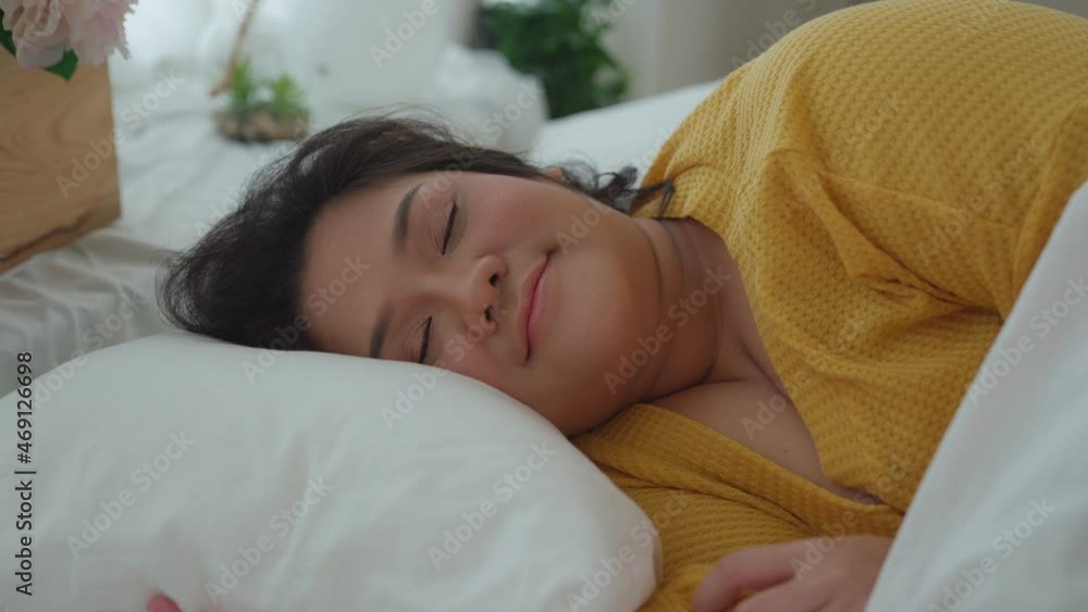 Asian woman girl sleeping well in comfortable cozy fresh bed on soft pillow. Female resting lying asleep enjoying healthy good sleep nap in the morning. Enjoying good healthy sleep Asian woman girl sleeping well in comfortable cozy fresh bed on soft pillow. Female resting lying asleep enjoying healthy good sleep nap in the morning. Enjoying good healthy sleep