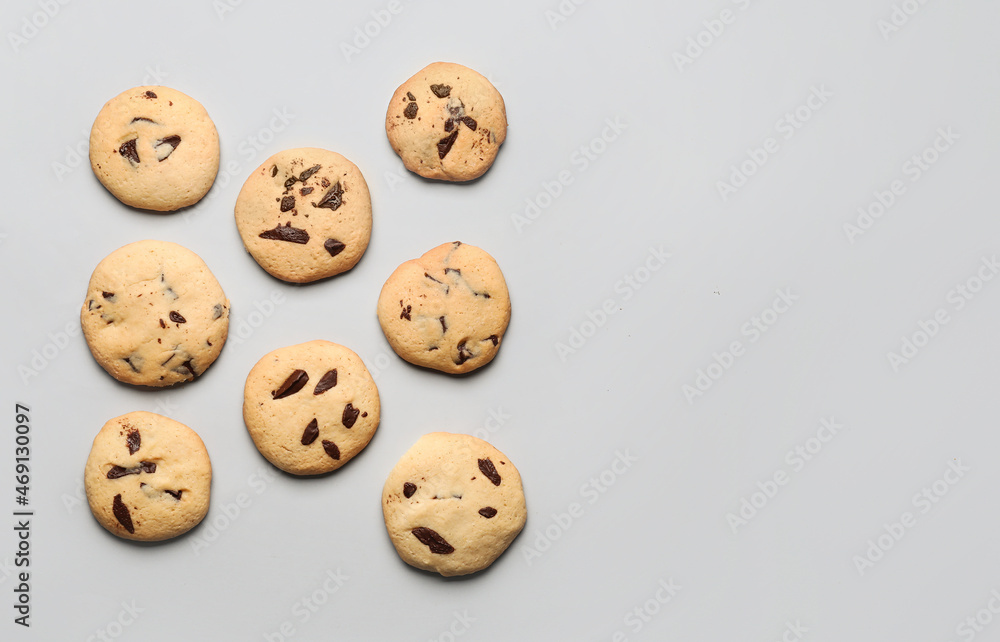 Delicious homemade cookies with chocolate chips on light background