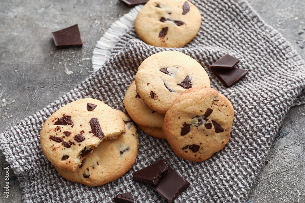 Delicious homemade cookies with chocolate chips on grey background