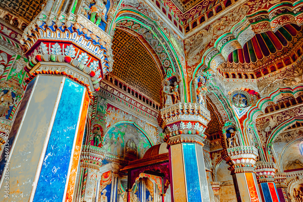 Thanjavur, Tamil Nadu, India - The high arches artworks and colorfully painted wall murals and ceilings of the ancient 17th-century durbar hall Maratha Palace in the town of Thanjavur