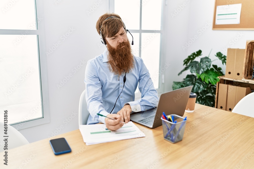 Young irish call center agent concentrate working at the office. Young irish call center agent concentrate working at the office.
