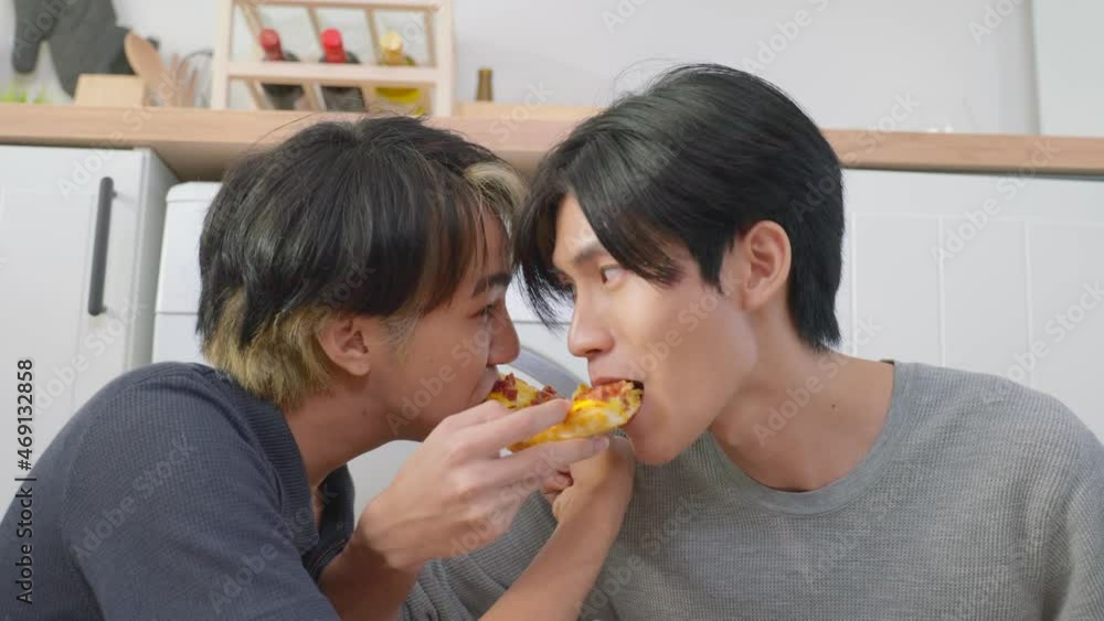 Asian handsome man gay family sitting on floor, eating pizza together.
Asian handsome man gay family sitting on floor, eating pizza together.