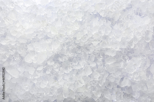 Clear crushed ice as background, top view photo