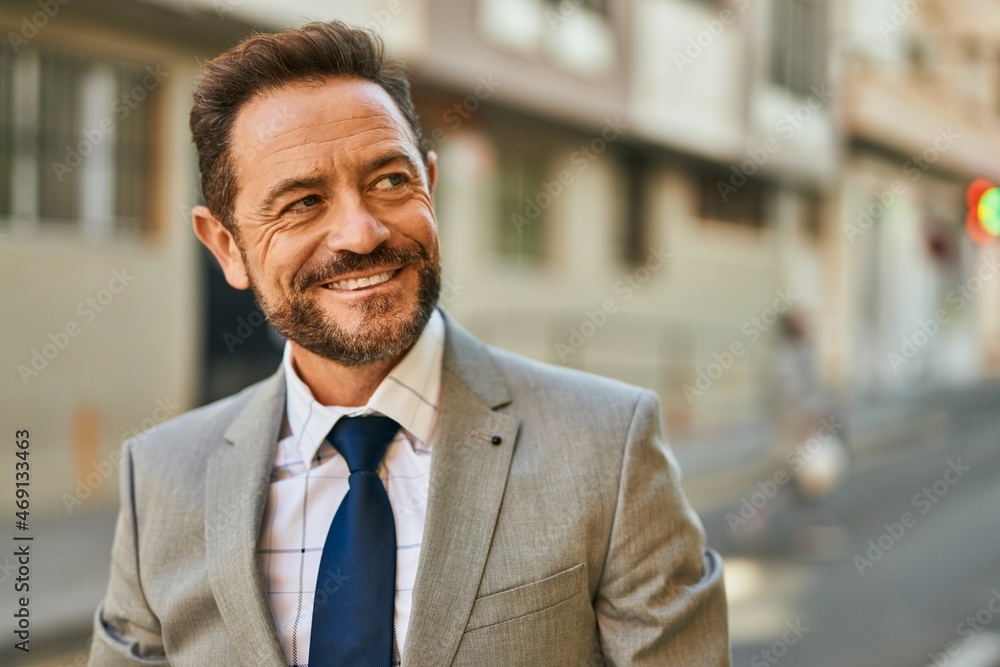 Middle age businessman smiling happy standing at the city. Middle age businessman smiling happy standing at the city.