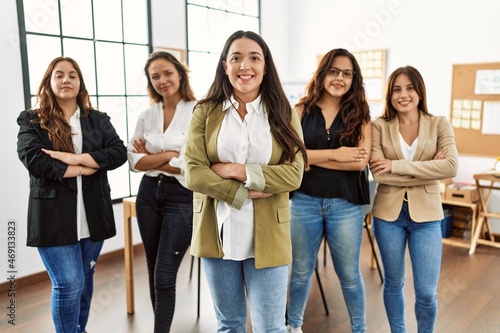 Group of young businesswomen smiling happy standing with arms crossed gesture at the office.