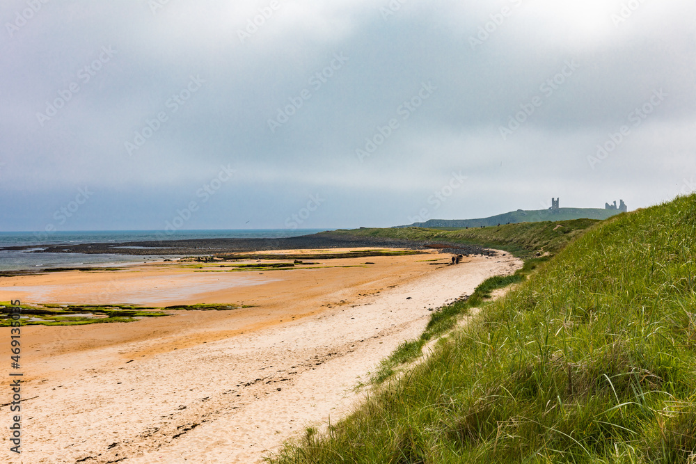 Embleton Bay and Burn sandy beach with the ruins of Dunstanburgh Castle
