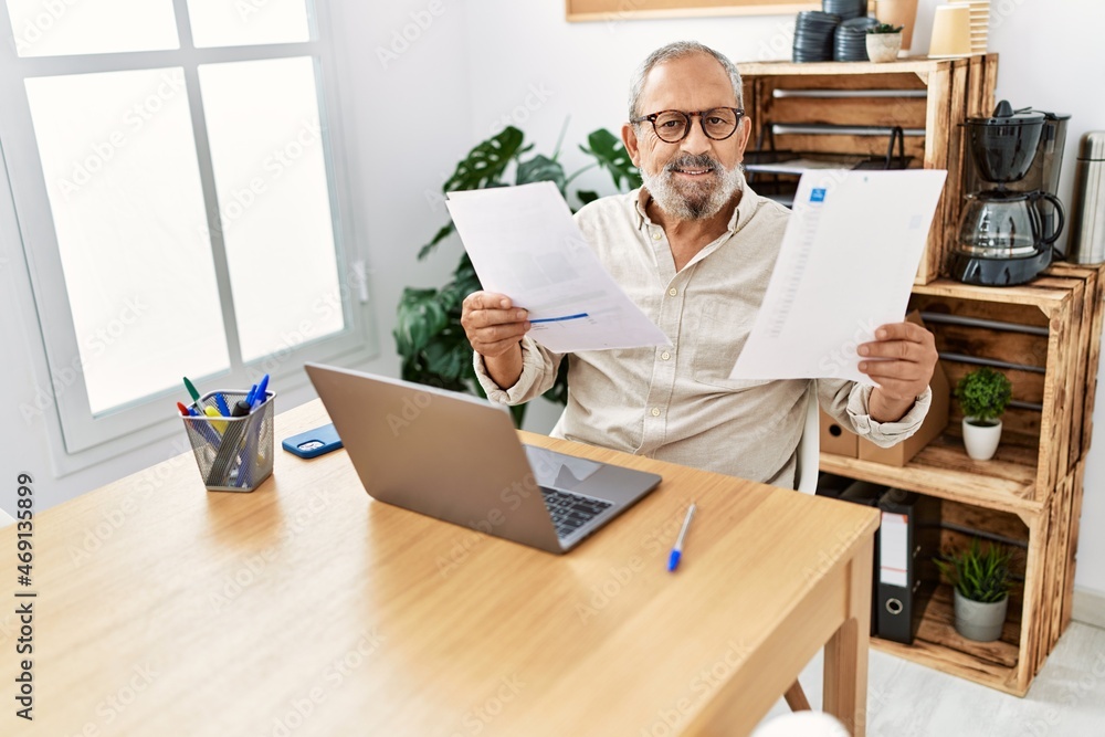 Senior grey-haired man smiling confident working at office Senior grey-haired man smiling confident working at office