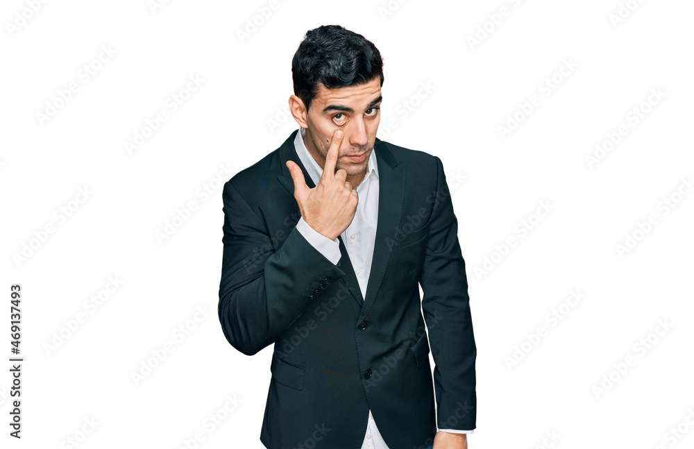Handsome hispanic man wearing business clothes pointing to the eye watching you gesture, suspicious expression Handsome hispanic man wearing business clothes pointing to the eye watching you gesture, suspicious expression