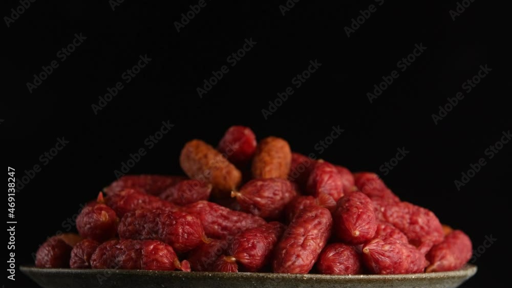 Mini smoked sausages on black background Mini smoked sausages on black background