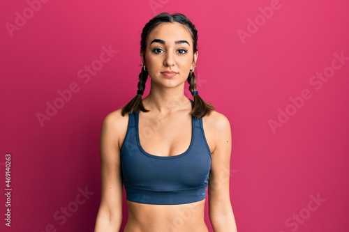 Young brunette girl wearing sportswear and braids relaxed with serious expression on face. simple and natural looking at the camera. © Krakenimages.com