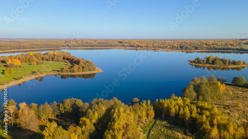 Majestic landscape photographed by drone. Aerial view of freshwater lake with island. Image for design and background.