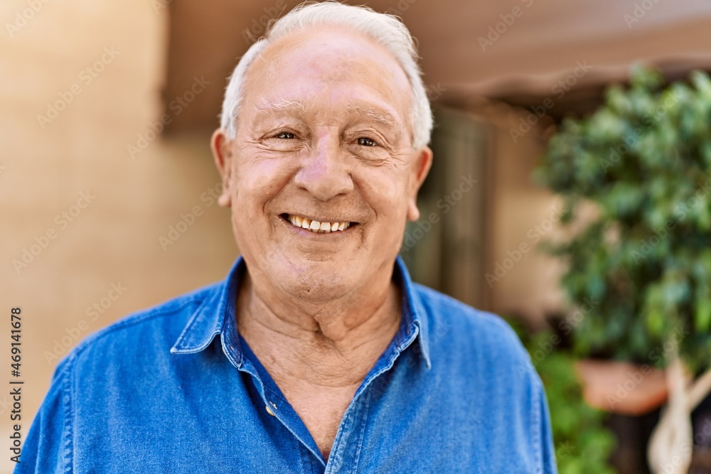 Senior man with grey hair standing happy outdoors on a sunny day. Smiling happy at 70s for retirement. Senior man with grey hair standing happy outdoors on a sunny day. Smiling happy at 70s for retirement.