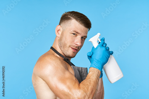 handsome man with pumped body cleanser cleaning housework