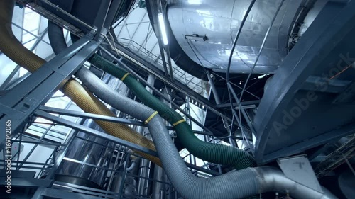 New metal industry inside. Dairy production plant with stainless tubes. Interior of modern milk factory. View from below. photo