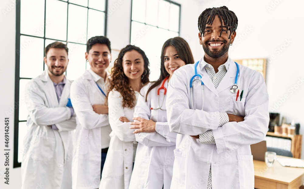 Group of young doctor smiling happy standing with arms crossed gesture at the clinic office. Group of young doctor smiling happy standing with arms crossed gesture at the clinic office.