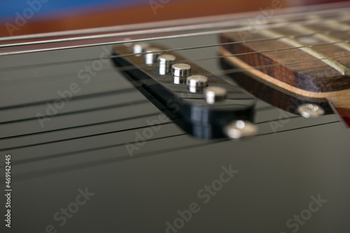 Close-up detail of the pickup of an electric guitar. They are transducers that capture the vibration of the strings