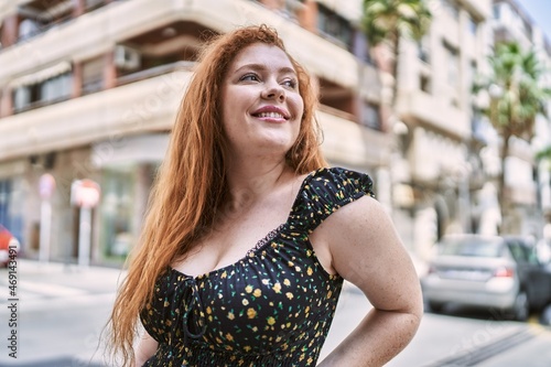 Young redhead girl smiling happy standing at the city. © Krakenimages.com