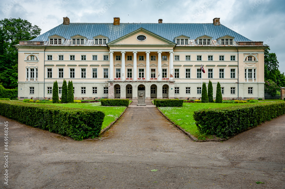 View to Kazdanga Palace built in the late classical style. The road leads to the entrance of palace. Latvia. Baltic.