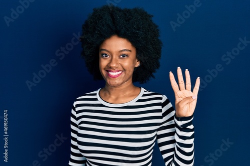 Young african american woman wearing casual clothes showing and pointing up with fingers number four while smiling confident and happy.