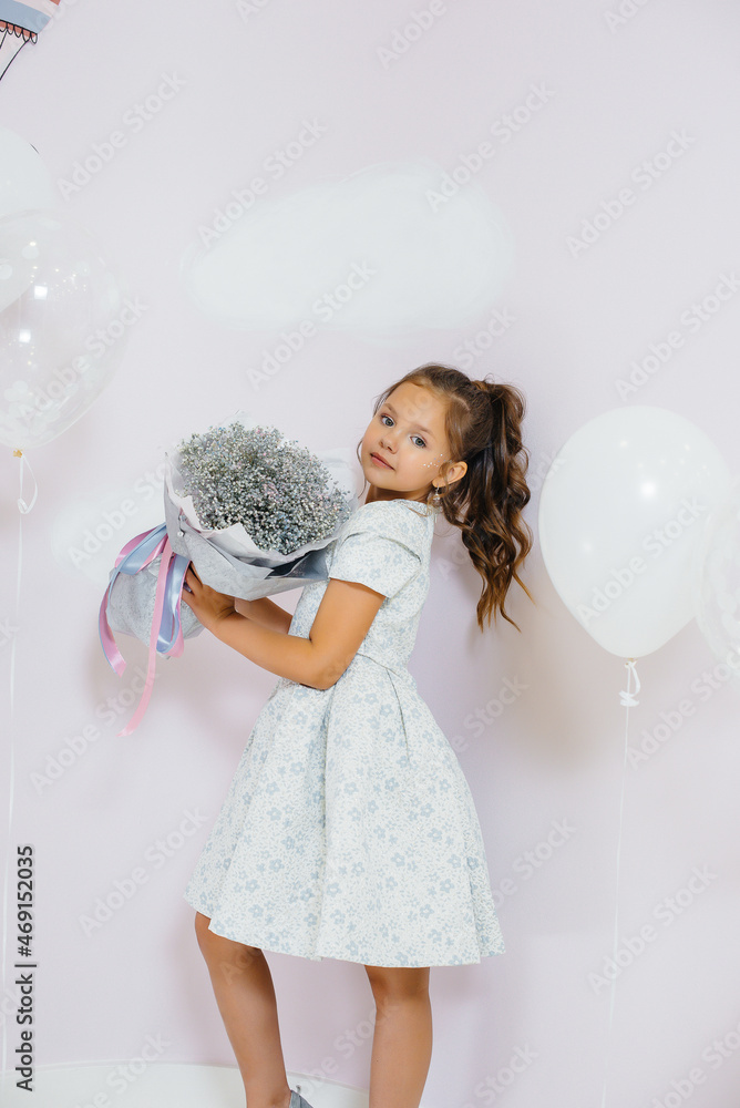 A cute little girl smiles and poses with a bouquet of flowers. A cute little girl smiles and poses with a bouquet of flowers.
