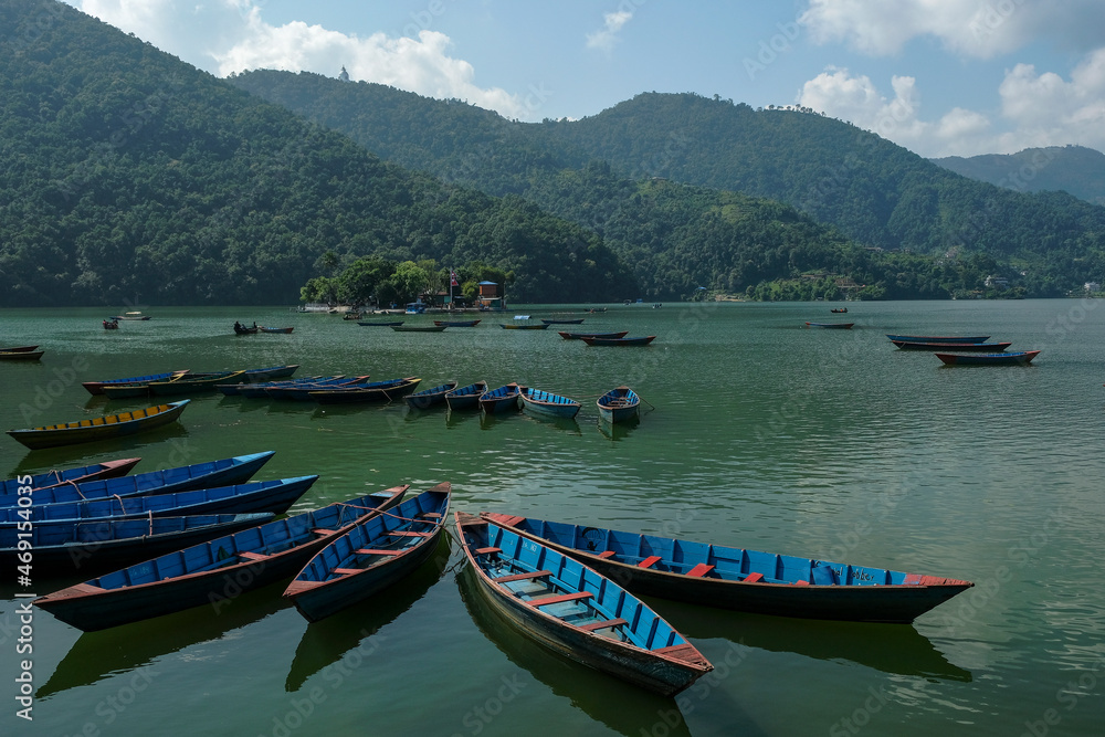 Pokhara, Nepal - October 2021: Boats on Lake Phewa in Pokhara on October 28, 2021 in Pokhara, Nepal.