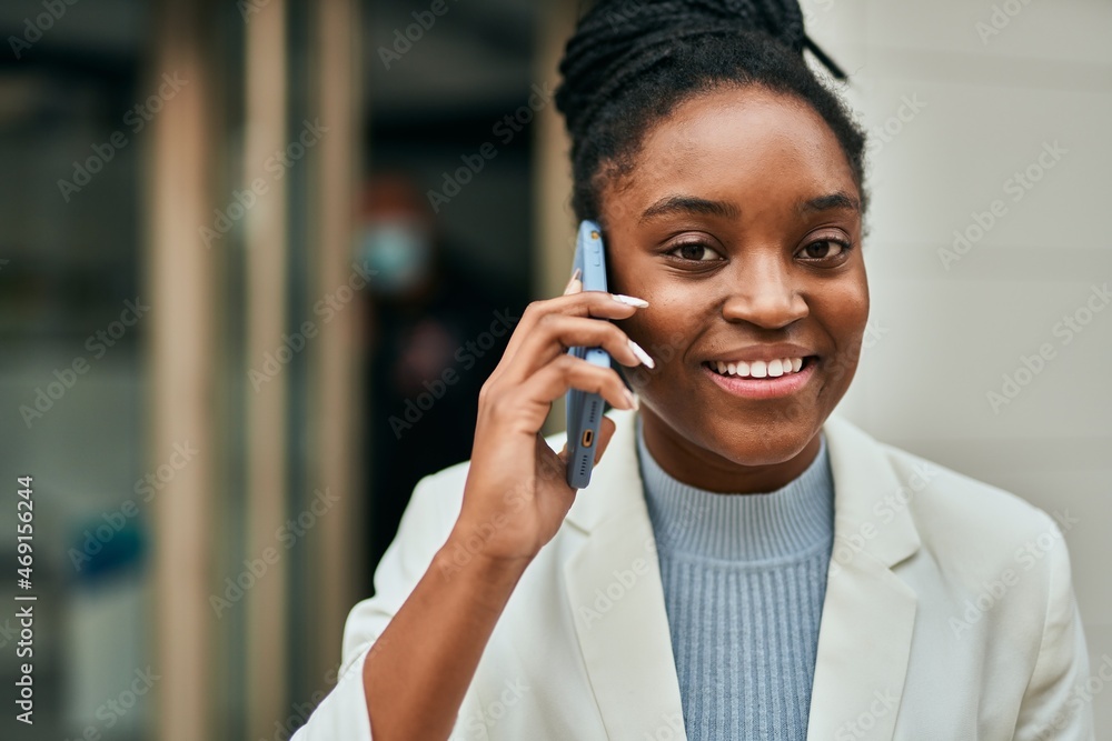 Young african american businesswoman smiling happy talking on the smartphone at the city. Young african american businesswoman smiling happy talking on the smartphone at the city.