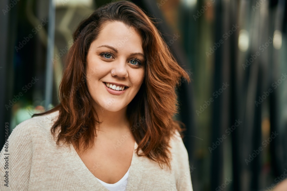 Fototapeta premium Young irish plus size girl smiling happy standing at the city.