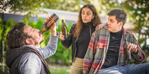 Photos Friends chugging bottle beer. Express drinking and fast get drunk
