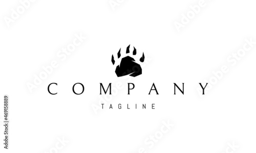 Vector logo on which the abstract image of a footprint of a bear in the form of a mountain.