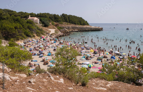 Sainte-Croix beach, Provence, France. August 14, 2021. The sandy beach is filled with vacationers. Ecological mediterranean sea beach. 