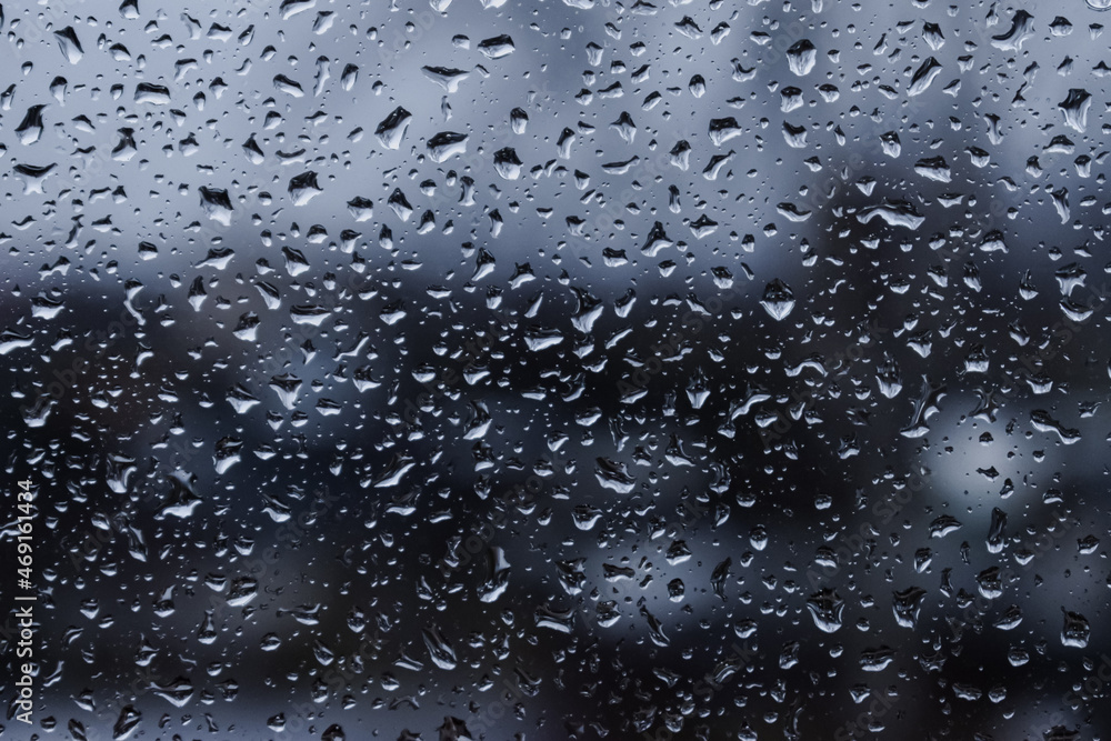Abstract blurred background. Raindrops on the glass against the background of the city. Autumn. selective focus Abstract blurred background. Raindrops on the glass against the background of the city. Autumn. selective focus