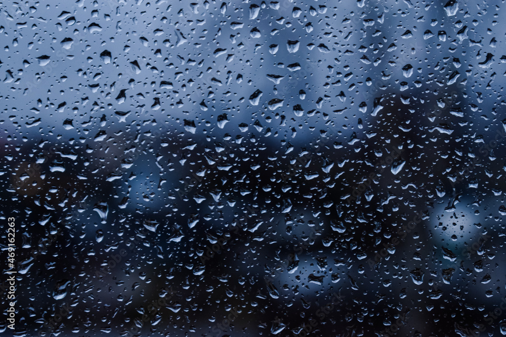 Abstract blurred background. Raindrops on the glass against the background of the city. Autumn. selective focus