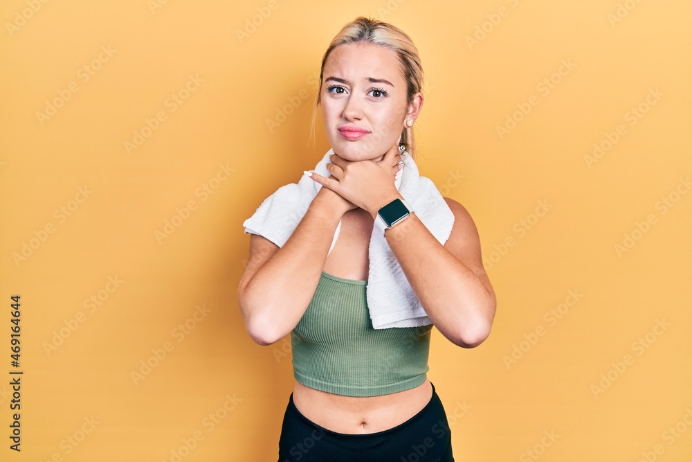 Young blonde girl wearing sportswear and towel shouting suffocate because painful strangle. health problem. asphyxiate and suicide concept. Young blonde girl wearing sportswear and towel shouting suffocate because painful strangle. health problem. asphyxiate and suicide concept.