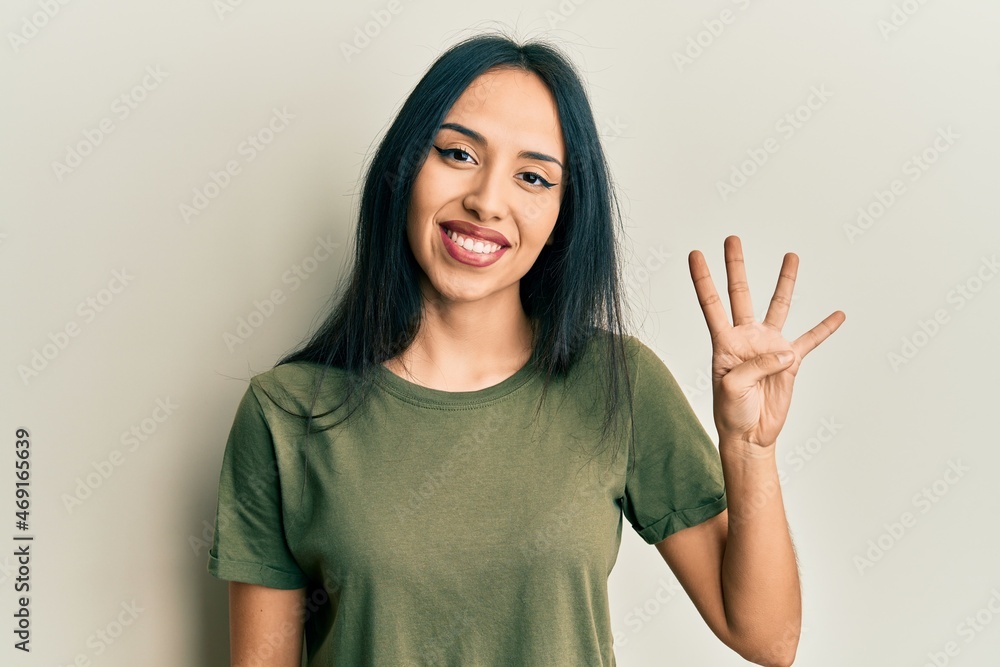 Young hispanic girl wearing casual t shirt showing and pointing up with fingers number four while smiling confident and happy. Young hispanic girl wearing casual t shirt showing and pointing up with fingers number four while smiling confident and happy.