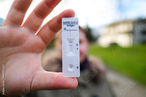 COVID-19 virus disease diagnostic, person holding coronavirus test cassette, rapid strep kit, quick antigen detection testing. Defocused