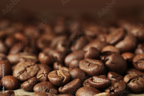 Heap of aromatic roasted coffee beans, closeup