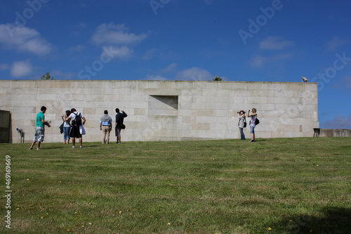People observing masive granite wall photo