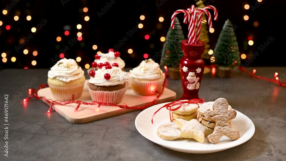 Christmas sweets, gingerbread cookies, cupcakes and candy canes on the table Christmas sweets, gingerbread cookies, cupcakes and candy canes on the table