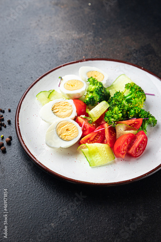 salad vegetables and egg, broccoli, tomato, cucumber, meal snack on the table copy space food background keto or paleo diet