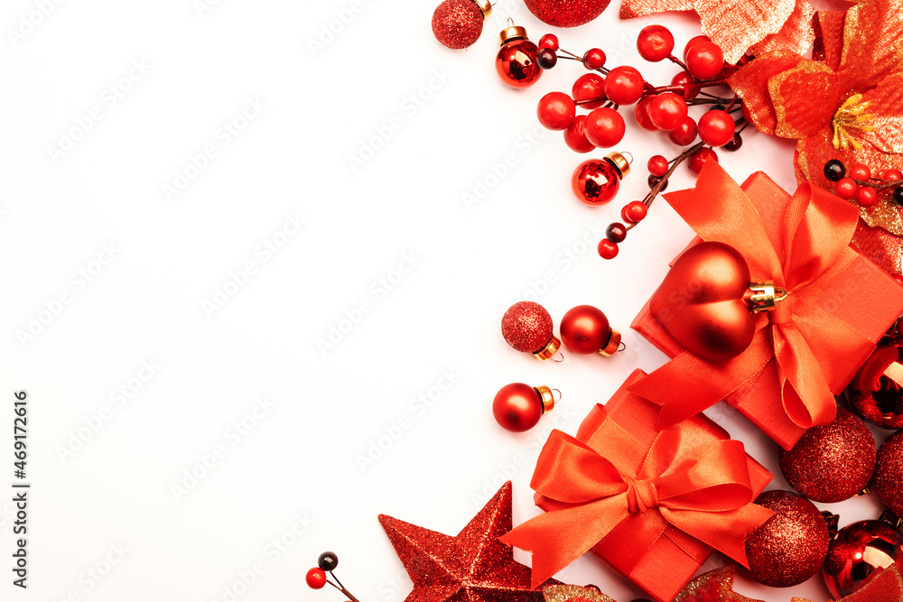White Christmas and New Year background with red Christmas balls, big star and berries, gift boxes. Top view, copy space White Christmas and New Year background with red Christmas balls, big star and berries, gift boxes. Top view, copy space