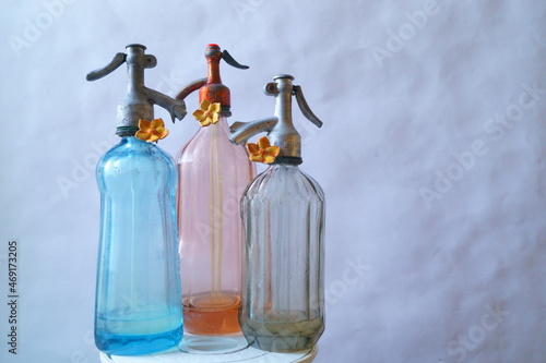 Fotografie Background with old objects - three bottles of soda water
