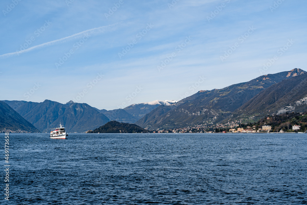 Ferry sails on Lake Como with mountains in the background