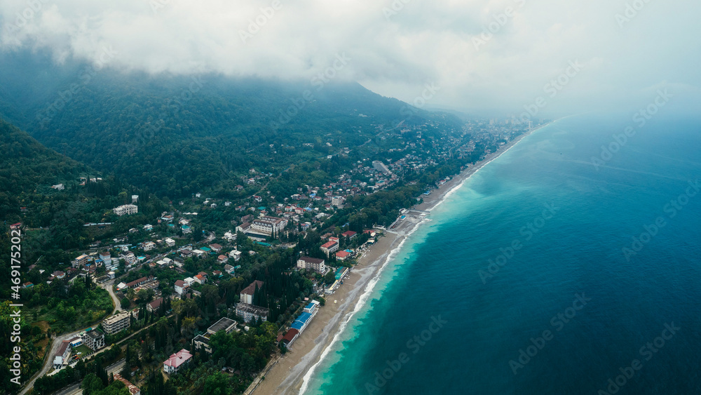 View from a height of the beach, mountains and sea in cloudy weather. Gagra, Abkhazia