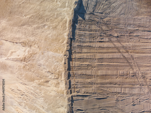 Aerial top down view of leveling ground with prints of bulldozer.