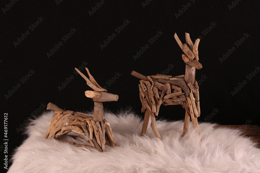 wooden deers with black background