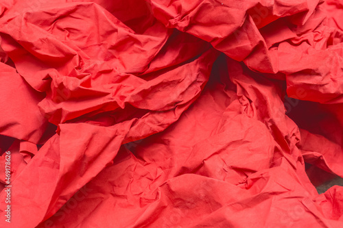 Shreds of old crumpled paper red close-up background