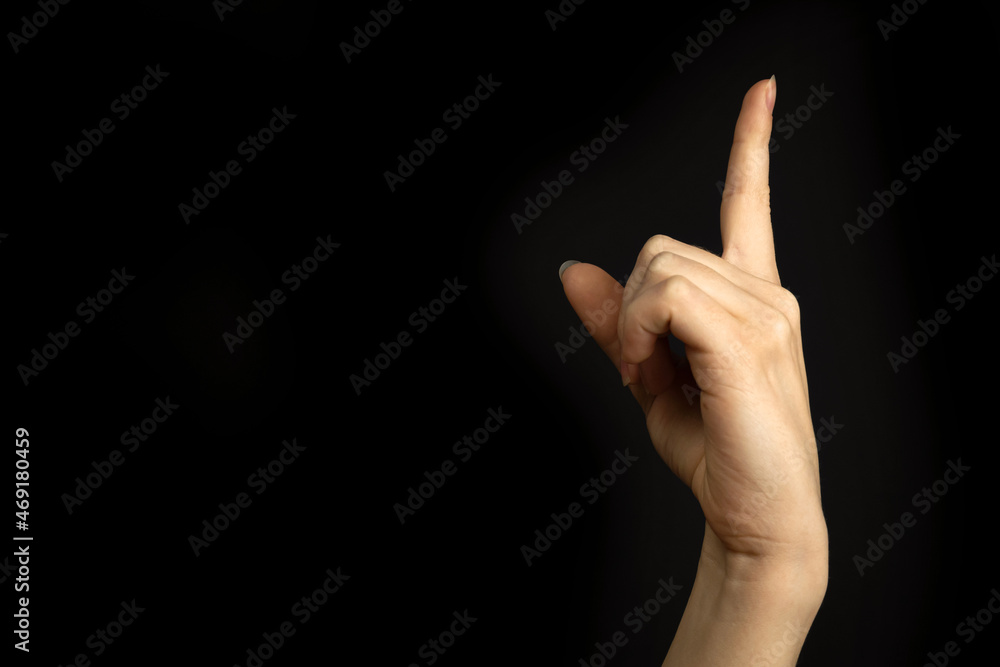 Hand point up. Education concept. Woman hand gesture, pointing sign, gesture look at this, pay attention. Black background photo Hand point up. Education concept. Woman hand gesture, pointing sign, gesture look at this, pay attention. Black background photo