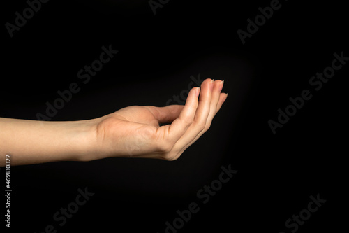 Young lady hand gesture on a black background isolated photo
