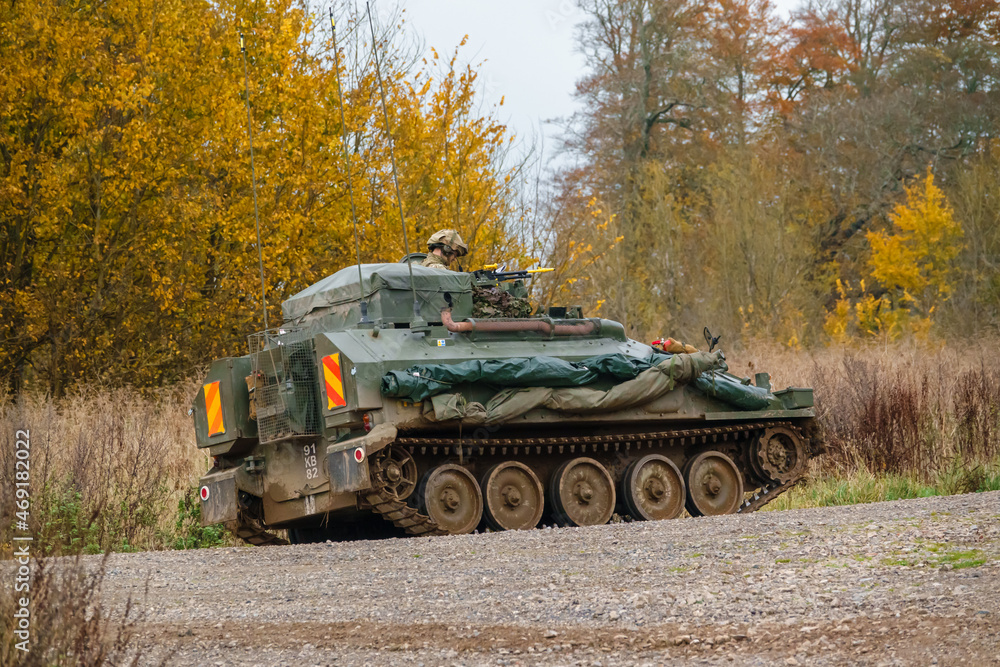 Fototapeta premium British army FV103 Spartan tracked armored reconnaissance vehicle in action on a military exercise Salisbury Plain, Wiltshire UK