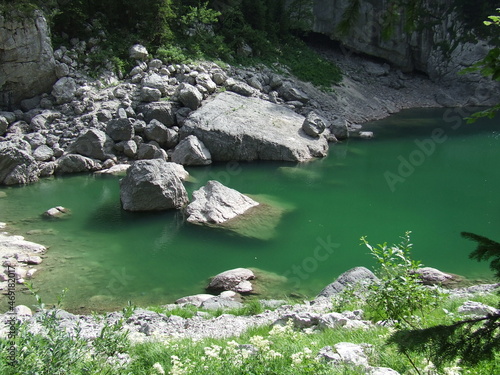 Beautiful landscape with mountainous rapid river. Big stone in river